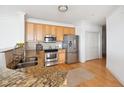 Updated kitchen boasting stainless steel appliances, granite countertops, and light wood cabinetry at 2244 Ashley Crossing Dr # 1232, Charleston, SC 29414