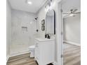 Modern bathroom boasts white vanity, a walk-in shower with marble tile, and wood-look flooring at 2325 Sorentrue Ave, North Charleston, SC 29405