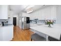 Bright kitchen with stainless steel appliances, white cabinets, and hardwood floors at 3075 Maritime Forest Dr, Johns Island, SC 29455