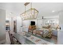 Open dining room featuring a modern chandelier and seamless flow to the living areas at 3304 Hartnett Blvd, Isle of Palms, SC 29451
