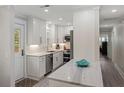 Beautiful kitchen with stainless steel appliances, white cabinetry, and white marble countertops at 3304 Hartnett Blvd, Isle of Palms, SC 29451