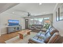 Inviting living room with comfortable leather seating, a ceiling fan, and plenty of natural light at 3552 Old Ferry Rd, Johns Island, SC 29455