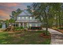 Inviting two-story home with lush landscaping and a private driveway, perfect for Gathering living at 4029 Cascades Thrust, Summerville, SC 29483