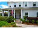 Charming front porch, featuring decorative plants, cozy seating, and a welcoming entrance at 4029 Cascades Thrust, Summerville, SC 29483