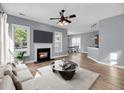 Bright living room with hardwood floors, fireplace, and open layout to dining area at 412 Hydrangea St, Summerville, SC 29483