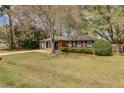Single-story brick home with landscaped front yard and mature trees at 4418 Hardwood St, Ladson, SC 29456