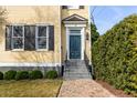 Inviting entrance of a home featuring a blue door, white trim, and brick pathway at 49 Ashley Ave, Charleston, SC 29401