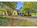 Beautiful two-story home featuring colorful exterior, set in a serene, tree-lined neighborhood at 5132 E Liberty Park Cir, North Charleston, SC 29405
