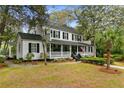 Charming two-story traditional home with a welcoming front porch and beautifully landscaped yard at 516 Central Ave, Summerville, SC 29483