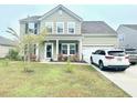 Charming two-story home with well-maintained landscaping and a two-car garage at 565 Mountain Laurel Cir, Goose Creek, SC 29445