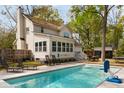Backyard with a refreshing pool, lounge chairs, a table, and a view of the house at 639 Bridlewood Ln, Mount Pleasant, SC 29464