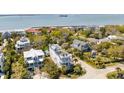 Expansive neighborhood aerial showcasing diverse houses, a rooftop deck, and proximity to the coast at 904 Middle St, Sullivans Island, SC 29482