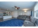 Bright living space with modern gray walls, sleek floors, and a comfortable sectional sofa at 9723 Flooded Field Dr, Ladson, SC 29456