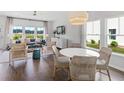 Bright living room features contemporary decor, large windows, and hardwood floors at 1027 Swamp Rose Run, Summerville, SC 29485