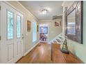 Warm and inviting foyer features hardwood floors, decorative mirror, and plenty of natural light at 104 Huckleberry Ln, Summerville, SC 29485