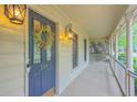 Inviting front porch with decorative wreath, charming lanterns, and exterior trim detail at 104 Huckleberry Ln, Summerville, SC 29485