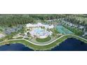 Breathtaking aerial view of community amenities, including pool, clubhouse, tennis courts, and lake at 1128 Darling St, Summerville, SC 29485
