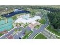 Gorgeous aerial view showcasing community amenities, including a pool, clubhouse, tennis courts, and lake at 1128 Darling St, Summerville, SC 29485