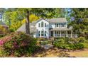 Inviting two-story home with lush landscaping, mature trees, and a cozy front porch at 116 Delaney Cir, Summerville, SC 29485