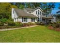 Attractive two-story home featuring blue shutters, landscaped garden, and a spacious green lawn at 116 Delaney Cir, Summerville, SC 29485