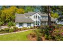 Beautiful two-story home with a well-maintained lawn and colorful flowering bushes at 116 Delaney Cir, Summerville, SC 29485