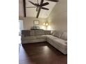 Spacious living room featuring a large sectional sofa, ceiling fan, exposed beams, and wood-look flooring at 129 Bramwell Dr, Summerville, SC 29485