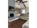 Comfortable living room with painted brick fireplace, built-in shelving, ceiling fan, and nice flooring at 129 Bramwell Dr, Summerville, SC 29485