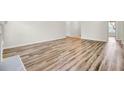Spacious living room featuring pristine wood flooring and freshly painted walls at 1302 Camden Xing, Hanahan, SC 29410