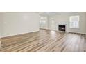 Bright living room showcasing a fireplace, wood flooring, and natural light at 1302 Camden Xing, Hanahan, SC 29410