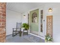 Welcoming front porch with a rocking chair, lush fern, and a decorative welcome sign at 1342 Dennis Blvd, Moncks Corner, SC 29461