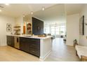 Stylish kitchen with stainless steel appliances, quartz countertops, and dark cabinetry at 135 Pier View # 305, Charleston, SC 29492