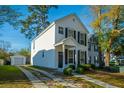 Well-maintained two-story residence with a cozy front porch, a long driveway, and a detached garage in the back at 137 St Phillips Row, Summerville, SC 29485