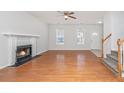Bright living area with gleaming hardwood floors, a classic fireplace, and abundant natural light at 137 St Phillips Row, Summerville, SC 29485