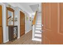 Bright foyer with hardwood floors, a decorative mirror, and stairs leading to the upper level at 14 Town Park Ln # B, Charleston, SC 29412