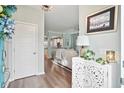 Bright entryway showcases a stylish carved cabinet and an inviting glimpse into the living spaces of the home at 1529 Fishbone Dr, Johns Island, SC 29455