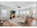 Inviting living room with stone fireplace, ceiling fan, hardwood floors and comfortable seating creates a relaxing atmosphere at 1529 Fishbone Dr, Johns Island, SC 29455
