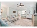 Spacious living room features hardwood floors, stylish decor, and seamless flow to adjacent dining and kitchen areas at 1529 Fishbone Dr, Johns Island, SC 29455