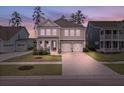 Gorgeous home with beautiful curb appeal, two-car garage, and a cozy front porch at 154 Calm Water Way, Summerville, SC 29486