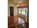 Bright dining area featuring wood floors, large windows and classic chandelier at 1561 Montclair St, Charleston, SC 29407