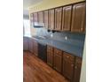 Kitchen featuring wood cabinets, laminate countertop, and stainless steel sink at 1561 Montclair St, Charleston, SC 29407
