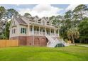 Attractive home with a classic design, prominent front porch, and verdant green lawn at 187 Pecan Dr, Summerville, SC 29483