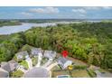 Aerial view of property with pool, lush surroundings, and close proximity to a lake at 1996 Wild Indigo Way, Hanahan, SC 29410