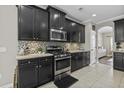 Modern kitchen features granite countertops, mosaic backsplash, and stainless steel appliances at 1996 Wild Indigo Way, Hanahan, SC 29410
