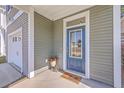 Inviting front entry featuring a blue door, neutral siding, and a 'hello' door mat at 2001 Poplar Grove Pl, Summerville, SC 29483