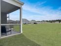 Large, lush backyard with covered porch offers relaxing views and ample space for outdoor activities at 215 Sweet Cherry Ln, Summerville, SC 29486