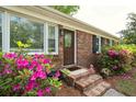Inviting front entrance with brick steps, decorative plants, and glass paneled door at 2158 Till Rd, Charleston, SC 29414