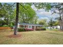 Beautiful home featuring brick facade, dark shutters, and lush landscaping at 2158 Till Rd, Charleston, SC 29414