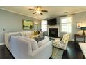 Open living area with fireplace, large sectional sofa and hardwood floors at 2160 Pentland Dr, Charleston, SC 29412