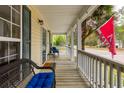 Cozy front porch with seating, overlooking the street and mature landscaping at 225 Hanahan Plantation Cir, Hanahan, SC 29410