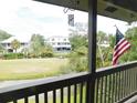 Scenic balcony view overlooking a lush golf course, pond and neighboring houses at 229 Linkside Villas # 1/3 Share, Edisto Beach, SC 29438